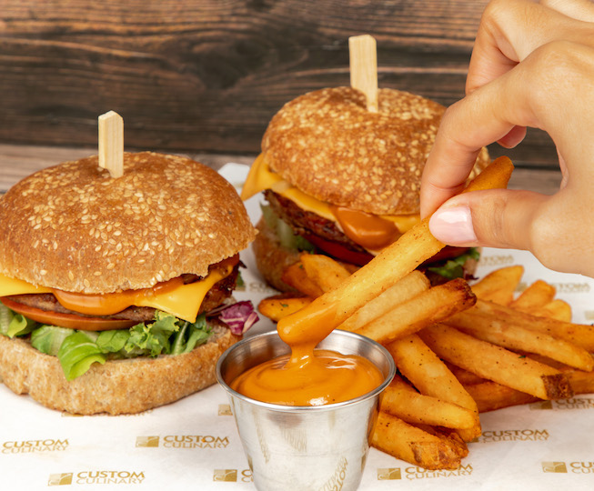 two burgers with thick cut fries with dipping sauce